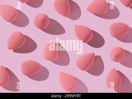 Multiple egg-shaped makeup sponges placed on a pink background. View from above. Stock Photo