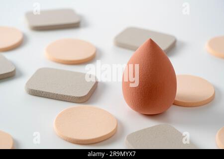 Makeup sponges of various shapes placed on a white background. Stock Photo