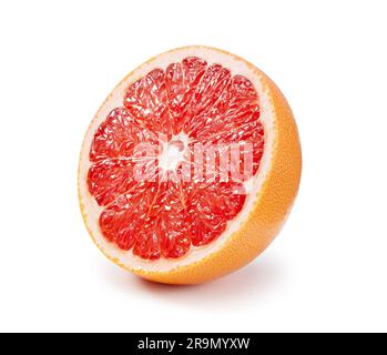 A grapefruit cut in half placed on a white background. Stock Photo