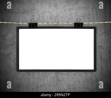 Blank tv screen hanging on a rope on concrete wall background. 3D rendering Stock Photo