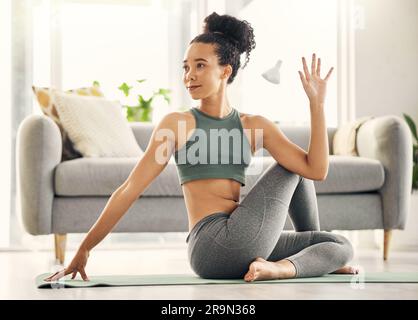 Stretching, body and yoga by woman on living room floor, training or mental health exercise at home. Arm, stretch and lady with flexible fitness or Stock Photo