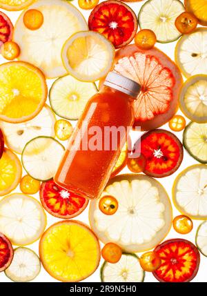 Bottle of fresh juice on the citrus background. Transparent pattern. Stock Photo
