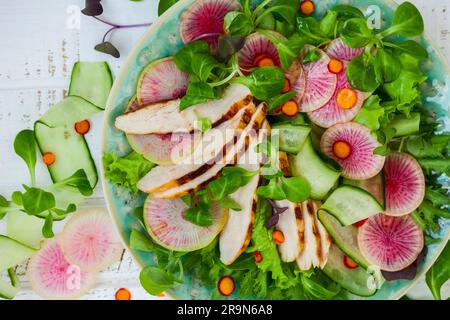 Grilled chicken salad  with cucumber and watermelon radish Stock Photo