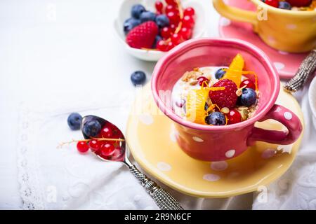Healthy breakfast with muesli, yogurt and fresh berries in cup Stock Photo