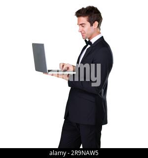 Male waiter, typing and laptop with service and suit in white background is working at restaurant. Butler, bowtie and technology with man in Stock Photo