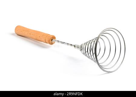 Close-up of old retro whisk kitchen tool on white background. Side view. High resolution photo. Full depth of field. Stock Photo