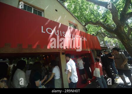 SHANGHAI, CHINA - JUNE 28, 2023 - People take photos of Louis Vuitton  coffee they just bought at the entrance of a Louis Vuitton cafe in  Shanghai, China, June 28, 2023. Recently