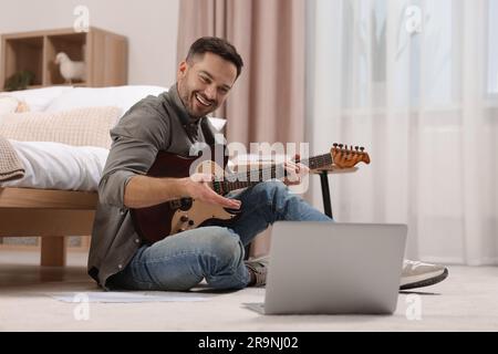 Music teacher talking with students while conducting online lesson at home. Time for hobby Stock Photo