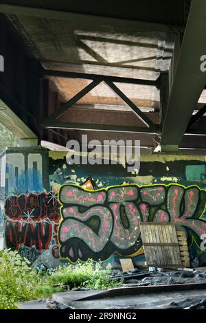 Contrasts. This image of graffiti by the Thames near Oxford does not show the traffic that - day and night - stream past on the bridge, carrying the c Stock Photo