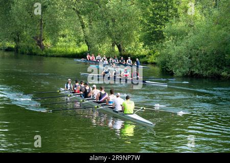 Rowing teams on the Thames at Iffley Village, just by its Lock and downstream of Oxford. It's early on a a summer morning, but you can see all sorts o Stock Photo