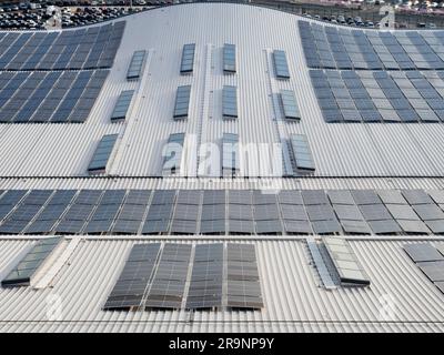 Looking down from a moored cruise ship onto the curved roof of the Horizon Cruise Terminal in Southampton, England, shows an abstract pattern of solar Stock Photo