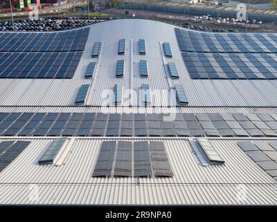 Looking down from a moored cruise ship onto the curved roof of the Horizon Cruise Terminal in Southampton, England, shows an abstract pattern of solar Stock Photo