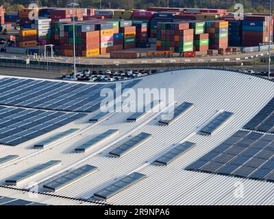 Looking down from a moored cruise ship onto the curved roof of the Horizon Cruise Terminal in Southampton, England, shows an abstract pattern of solar Stock Photo