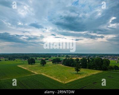 Aerial view of dramatic storm clouds over farm fields. Country landscape of the bad weather. Very windy weather. Plain field against the background of dark sky and clouds forming. High quality photo taken by a drone Stock Photo