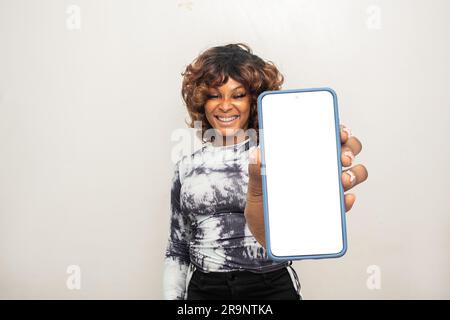 young african woman showing her phone screen Stock Photo