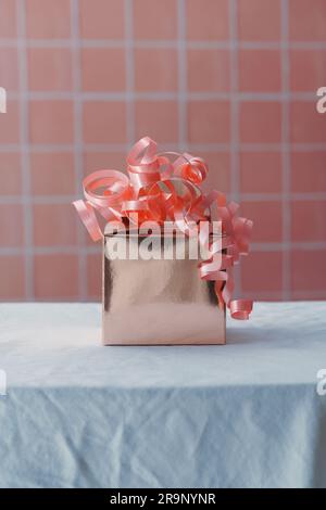 Pink gift box or present. Celebration concept image with bright pink colour theme and copy space available Stock Photo