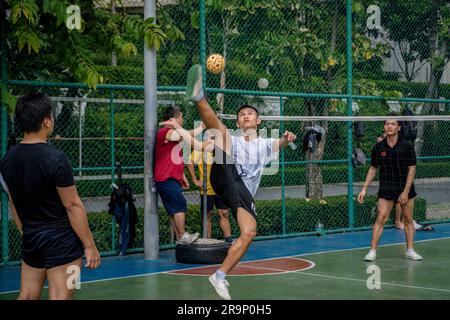 Bangkok, Thailand. 25th June, 2023. A Thai player of Sepak Takraw is seen performing an acrobatic figure during a game at Benchasiri Public Park Sukhumvit Road. Sepak Takraw also called kick volleyball or Thailand's Acrobatic Volleyball is one of Southeast Asia's most popular sports which is played with a ball made of rattan or synthetic plastic where the players are only allowed to touch the ball with their feet, body, or head. (Photo by Nathalie Jamois/SOPA Images/Sipa USA) Credit: Sipa USA/Alamy Live News Stock Photo
