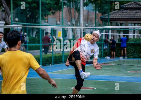 Bangkok, Thailand. 25th June, 2023. Players of Sepak Takraw are seen playing a game at Benchasiri Public Park n Sukhumvit Road. Sepak Takraw also called kick volleyball or Thailand's Acrobatic Volleyball is one of Southeast Asia's most popular sports which is played with a ball made of rattan or synthetic plastic where the players are only allowed to touch the ball with their feet, body, or head. (Photo by Nathalie Jamois/SOPA Images/Sipa USA) Credit: Sipa USA/Alamy Live News Stock Photo