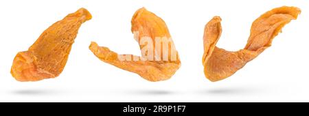 Flying dried fruits. Pieces of dried mango on a white isolated background. Mango from different angles hanging or falling. Dried mango isolate pieces Stock Photo