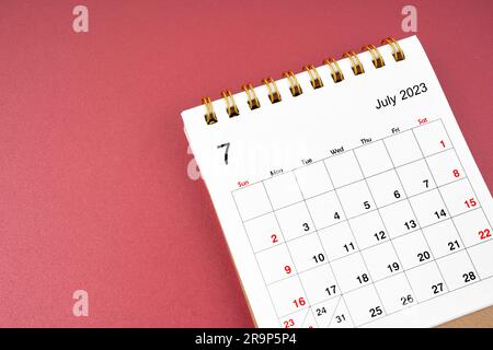 July 2023 calendar desk for the organizer to plan and reminder isolated on red background. Stock Photo