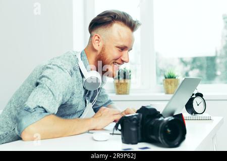 Photographer selecting photos on his computer Stock Photo
