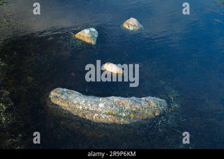 A natural smiley made of stones in the middle of a puddle in the Scottish Hoghlands. Stock Photo