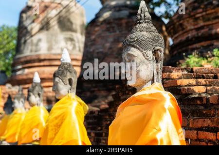 Aligned Buddha statues at Wat Yai Chai Mongkol (or Mongkhon), Ayutthaya, Thailand.  Wat Yai Chai Mongkol  is buddhist temple complex in Ayutthaya near Stock Photo