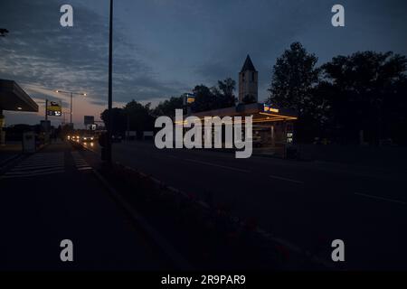 IP  branded gas station by the edge of a country road at dusk Stock Photo