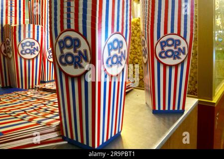 Close-up on a stack empty popcorn boxes before a popcorn maker. Stock Photo