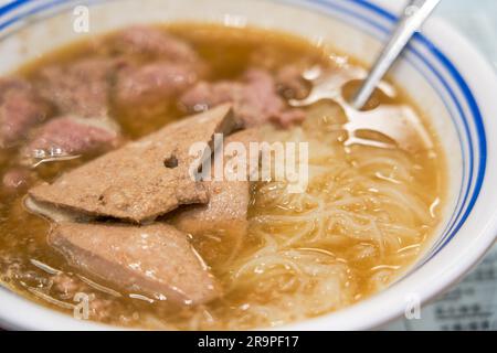 A bowl of delicious rice noodles with pork liver and pork in a tea restaurant in Hong Kong Stock Photo