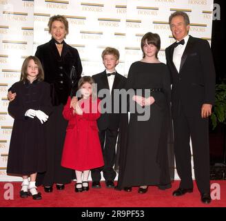 2004 Kennedy Center Honoree Warren Beatty, right, arrives with his wife, Annette Bening, and children, from left, Isabel, Ella, Benjamin, and Kathryn at the Harry S. Truman Building (Department of State) in Washington, D.C. on December 4, 2004 for a dinner hosted by United States Secretary of State Colin Powell.  At the dinner six performing arts legends will receive the Kennedy Center Honors of 2004.  This is the 27th year that the honors have been bestowed on 'extraordinary individuals whose unique and abundant artistry has contributed significantly to the cultural life of our nation and the Stock Photo
