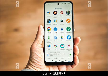 hand holding a smartphone with internet and apps logo on the screen Stock Photo