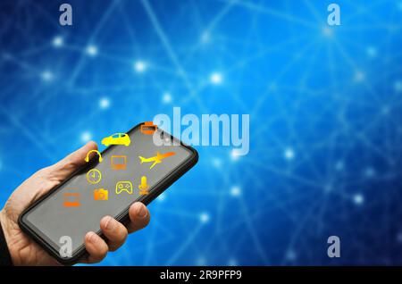 holding a smartphone with icon of connected tools and machines, IoT concept Stock Photo