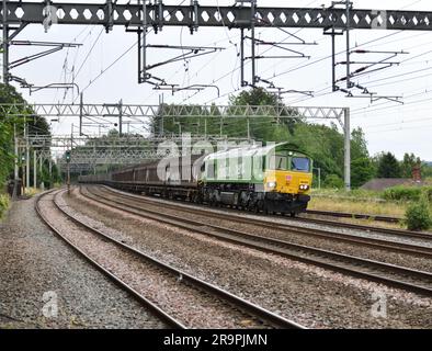 Green HVO fuelled DB Cargo Class 66 66004 working Dollands Moor Sidings to Ditton Foundry Lane approaches Rugeley Trent Valley on 28 June 2023 Stock Photo