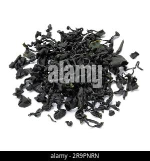 Heap of dried wakame seaweed isolated on white background close up Stock Photo