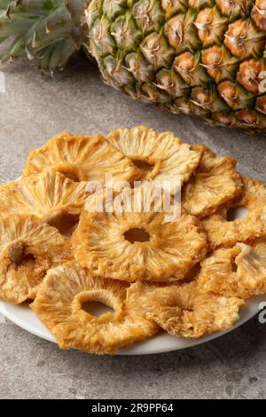 Plate with dried sweet pineapple slices close up Stock Photo