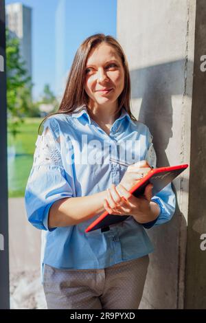 Confident businesswoman working at a modern office, using a laptop ...