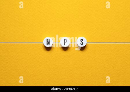 NPS - NET PROMOTER SCORE, word concept on building blocks, text, letters Stock Photo