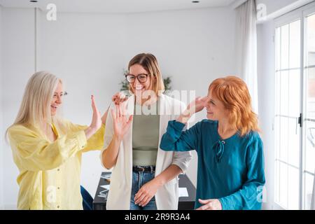 Group of company managers high-fiving their hands to celebrate the new union. Concept: business, investment, teamwork Stock Photo