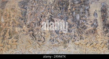 A captivating display of ancient art, featuring detailed carvings of Hindu mythology's battle scenes on the walls of a historic Khmer temple. Stock Photo