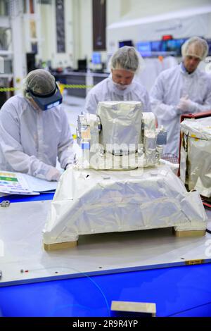 OpComm Delivery For Orion Artemis II. Inside the high bay of the Neil Armstrong Operations and Checkout Building at NASA’s Kennedy Space Center in Florida, technicians work on the Optical Communications System for the Artemis II mission on June 2, 2023. Optical communications is the latest space communications technology that is able to provide data rates as much as a hundred times higher than current systems. This will allow astronauts to send and receive ultra-high-definition video from the surface of the Moon or other planets such as Mars. Artemis II will be the first Artemis mission flying Stock Photo