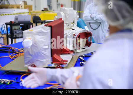 OpComm Delivery For Orion Artemis II. Inside the high bay of the Neil Armstrong Operations and Checkout Building at NASA’s Kennedy Space Center in Florida, technicians assemble on the Optical Communications System for the Artemis II mission on June 2, 2023. Optical communications is the latest space communications technology that is able to provide data rates as much as a hundred times higher than current systems. This will allow astronauts to send and receive ultra-high-definition video from the surface of the Moon or other planets such as Mars. Artemis II will be the first Artemis mission fl Stock Photo