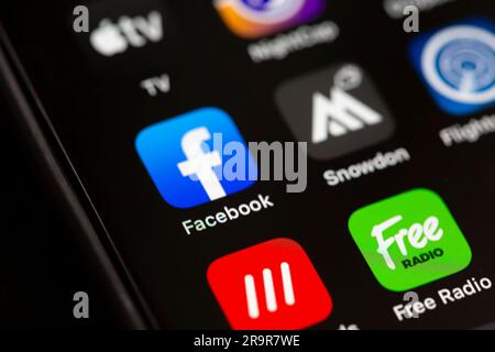 A close up of the Facebook app icon on an Apple smartphone screen. Stock Photo