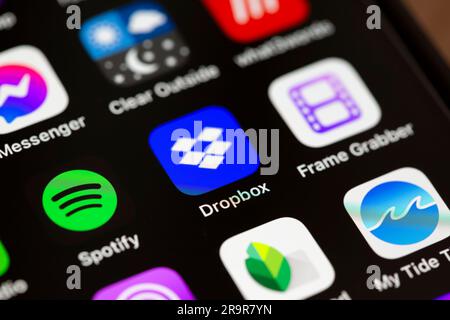 A close up of the Dropbox app icon on an Apple smartphone screen. Stock Photo