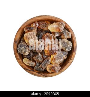 Large caramelized sugar in wooden bowl isolated on white background. Top view Stock Photo