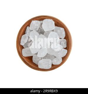 Close-up of organic crystalline rock sugar candy in wooden bowl isolated on white background. Top view Stock Photo