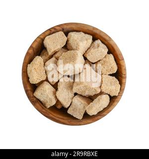 Brown cane sugar cubes in wooden bowl isolated on white background. Top view Stock Photo