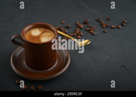 Cup of coffee with coffee beans on black background, Stock Photo