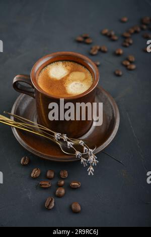 Cup of coffee with coffee beans on black background Stock Photo