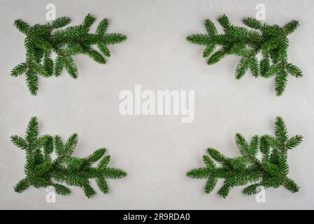 Decorative frame of fir branches. Christmas holiday background with copy space for text. Flat lay, top view. Stock Photo